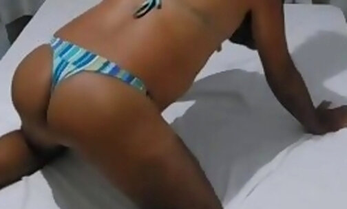 Latina crossdress LadyPamela in bed showing off her hot ass in bikini on webcam