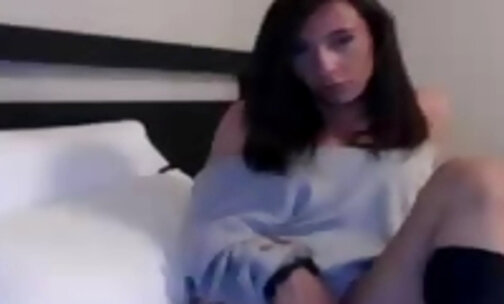 Cute tranny in bed stroking her cock