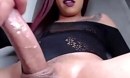 purple haired slim tgirl tugs her huge dick on webcam