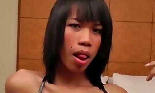 Short-haired ladyboy in leather shorts gets fucked doggystyle in bed