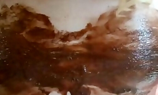 Naked body covered in chocolate sauce